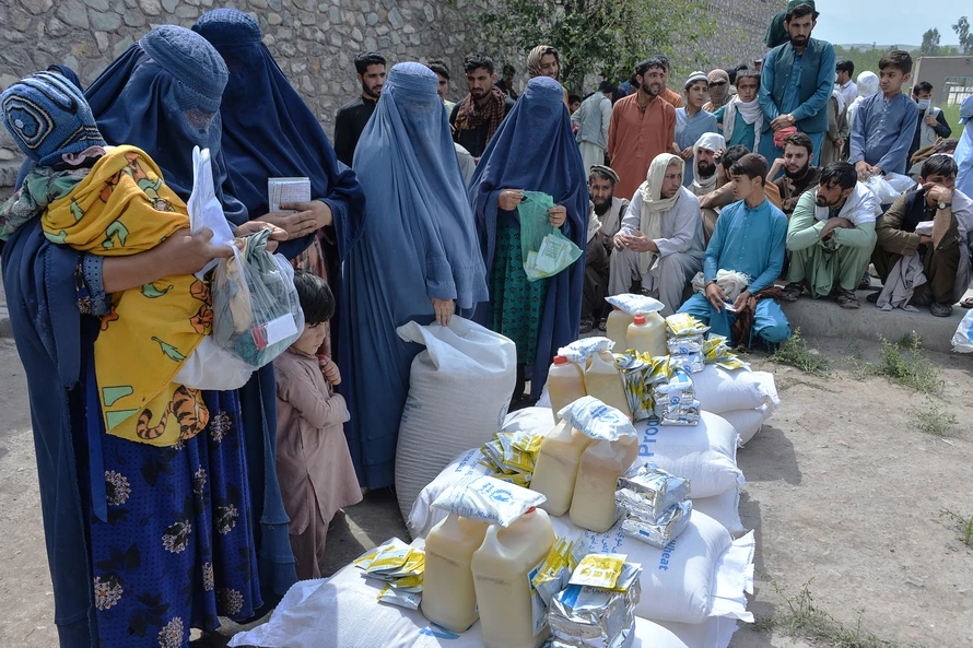 Người dân nhận lương thực cứu trợ tại Jalalabad, Afghanistan, ngày 20/4/2021. Ảnh: AFP/TTXVN
