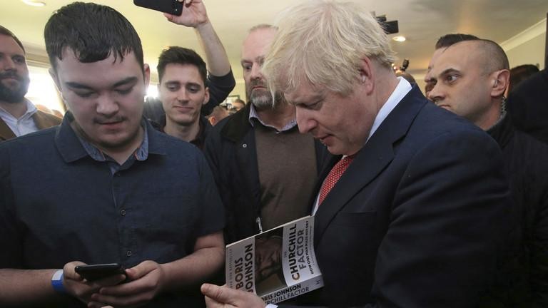 Thủ tướng Boris Johnson ký tặng sách do ông viết năm 2019. Ảnh: AP